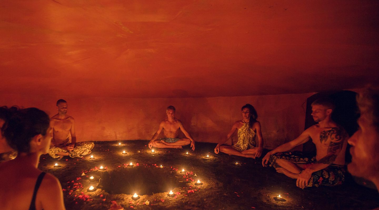 A group of people inside a temazcal.