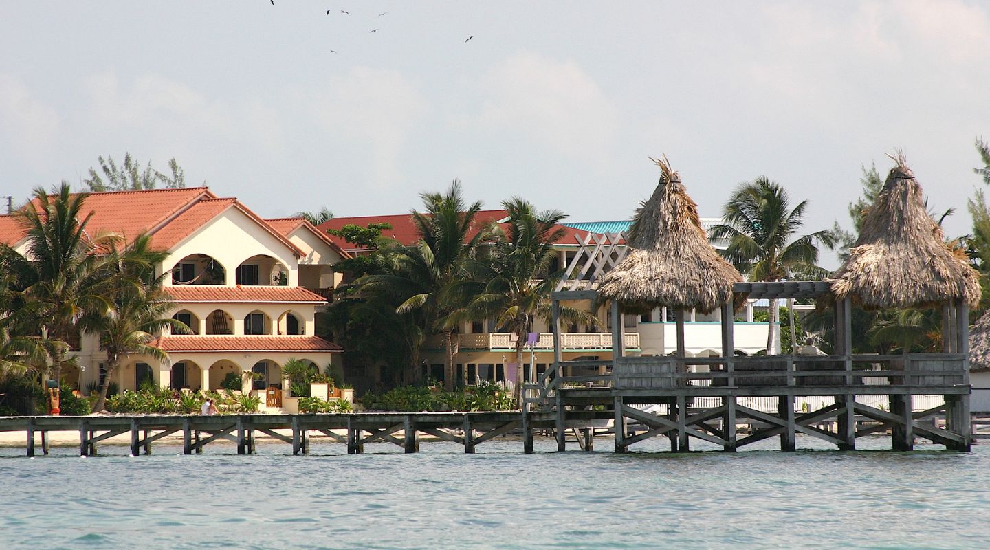 A small dock with beautiful buildings seen from the ocean