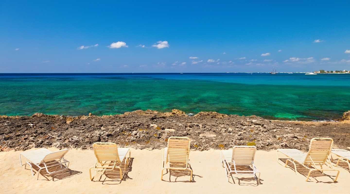 Single row of beach chairs overlooking the ocean.