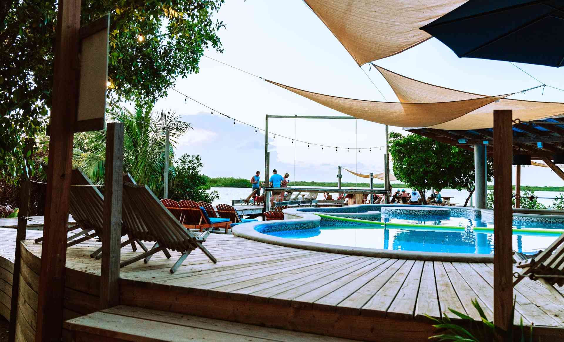 poolside with people and ocean in background