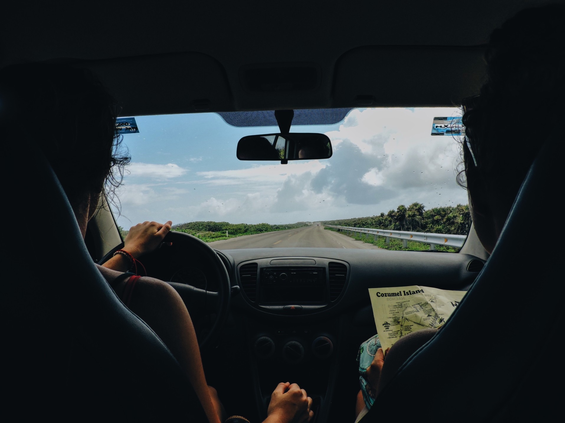 couple driving down the road in car