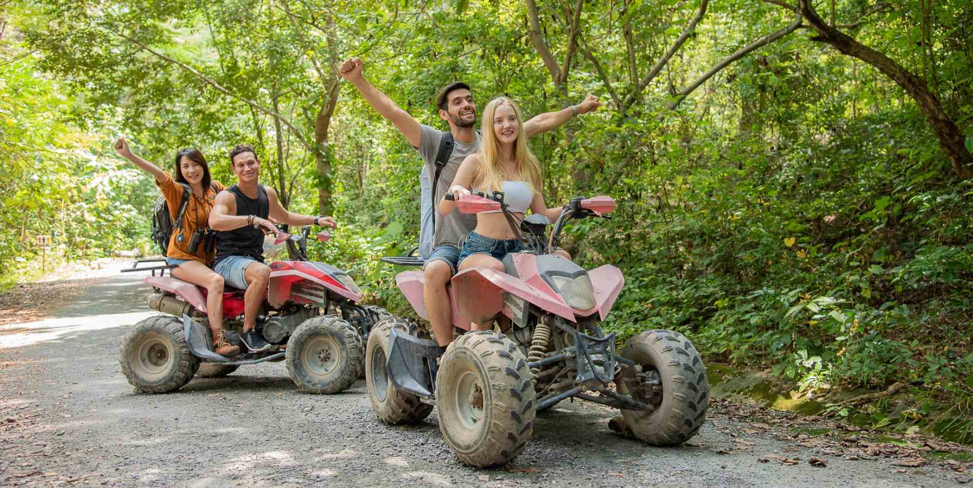 two couples riding atvs in the jungle