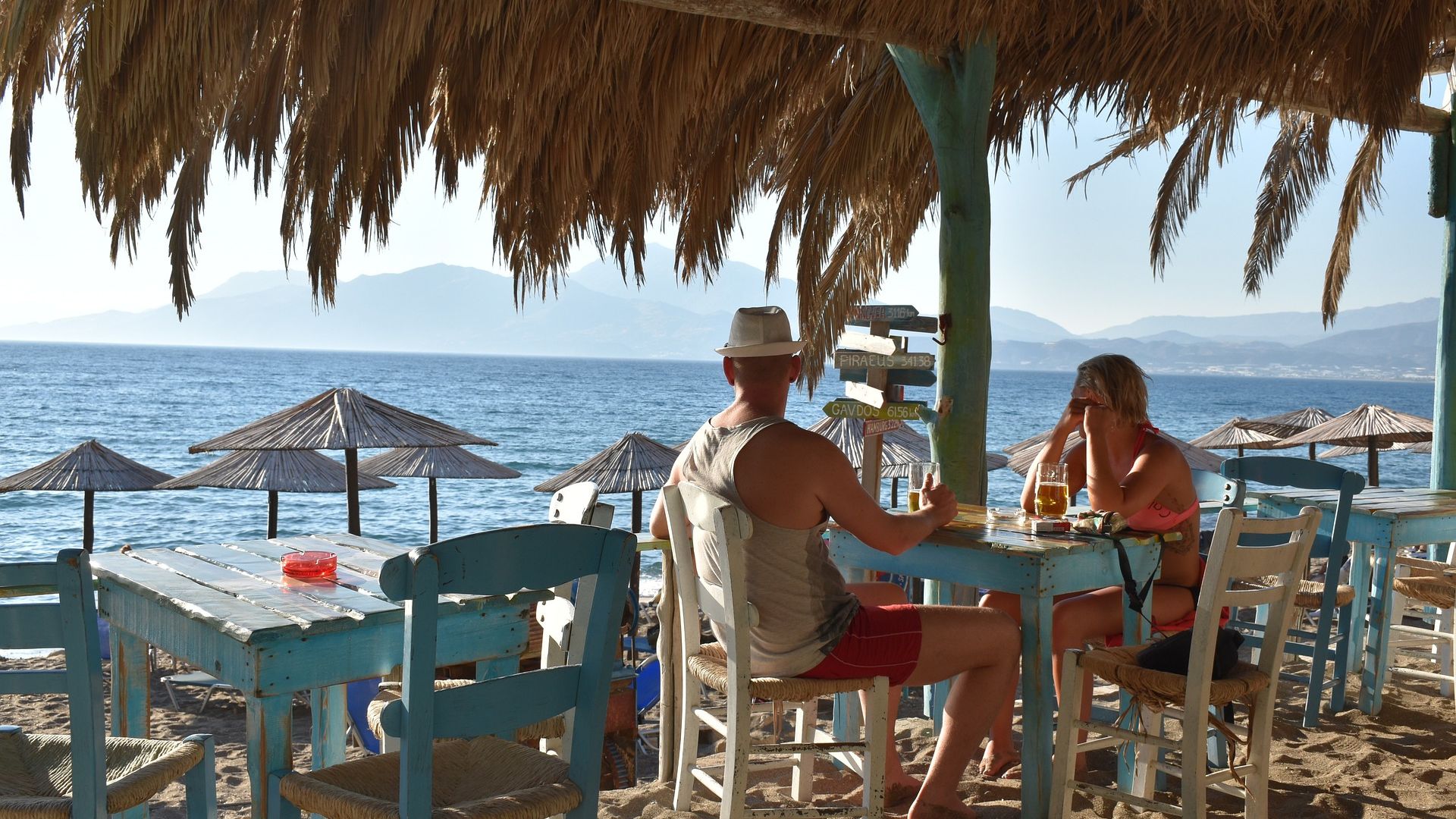 A couple sitting at a beachside bar