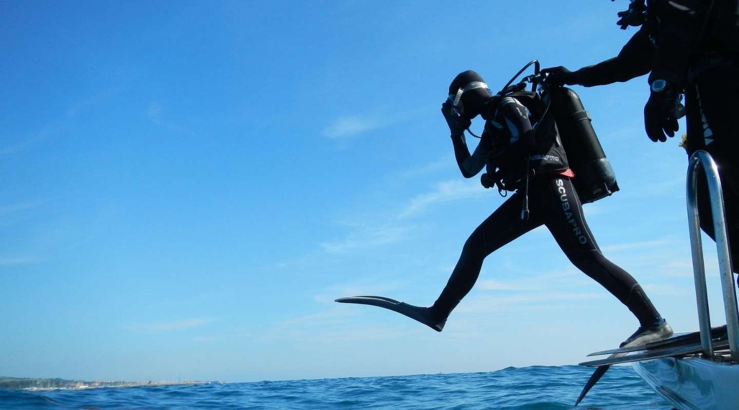 Diver jumping into the ocean.