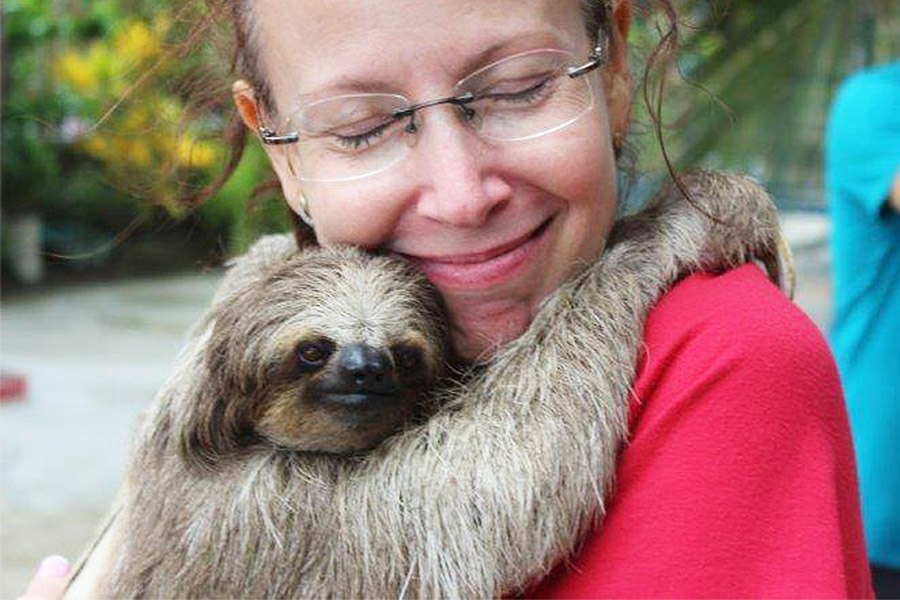 Woman holding a sloth photo by Daniel Johnson's Monkey and Sloth Hangout (https://www.facebook.com/DanielJohnsonsMonkeyandSlothHangout/photos)