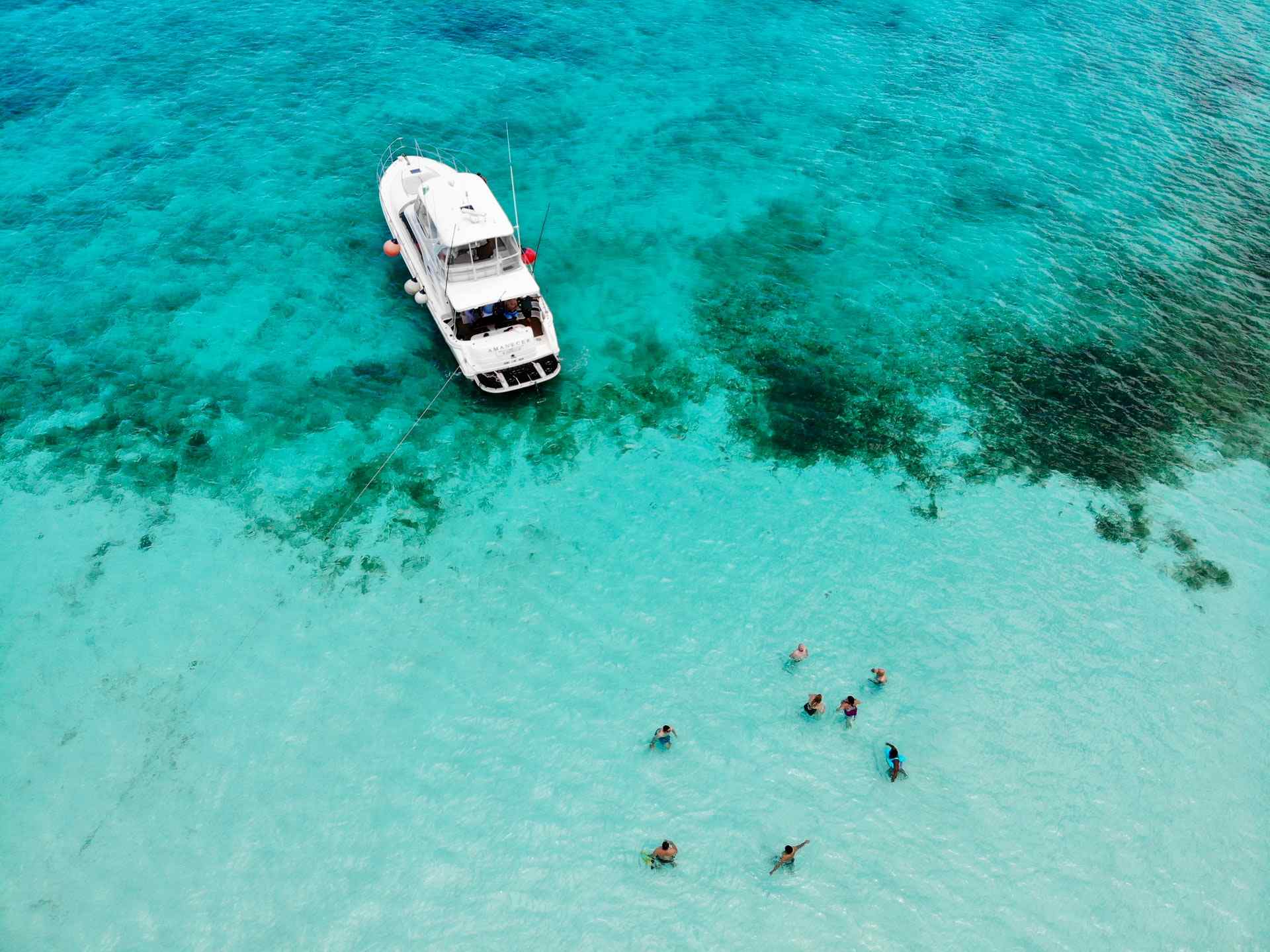 yacht and swimmers in tropical waters of Cozumel