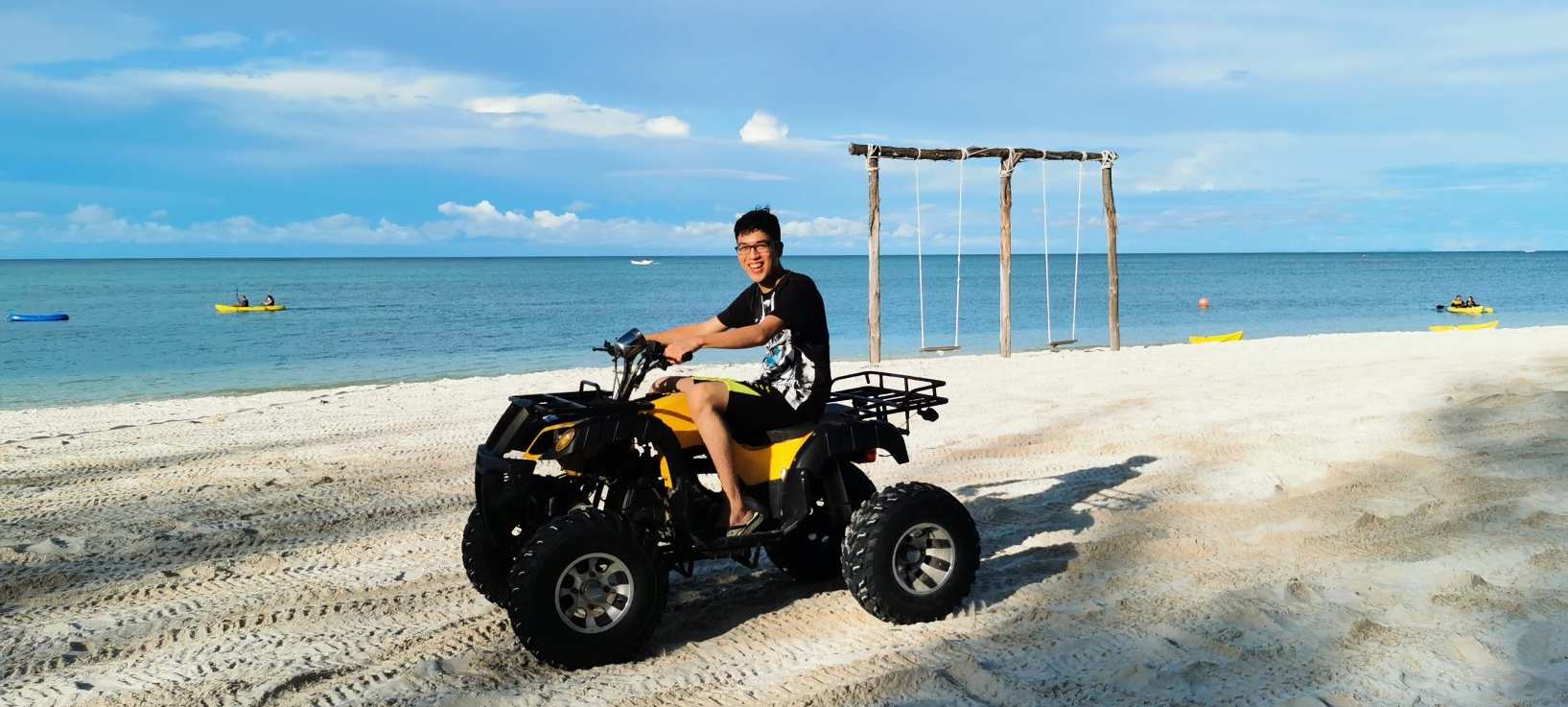 man riding atv on beach