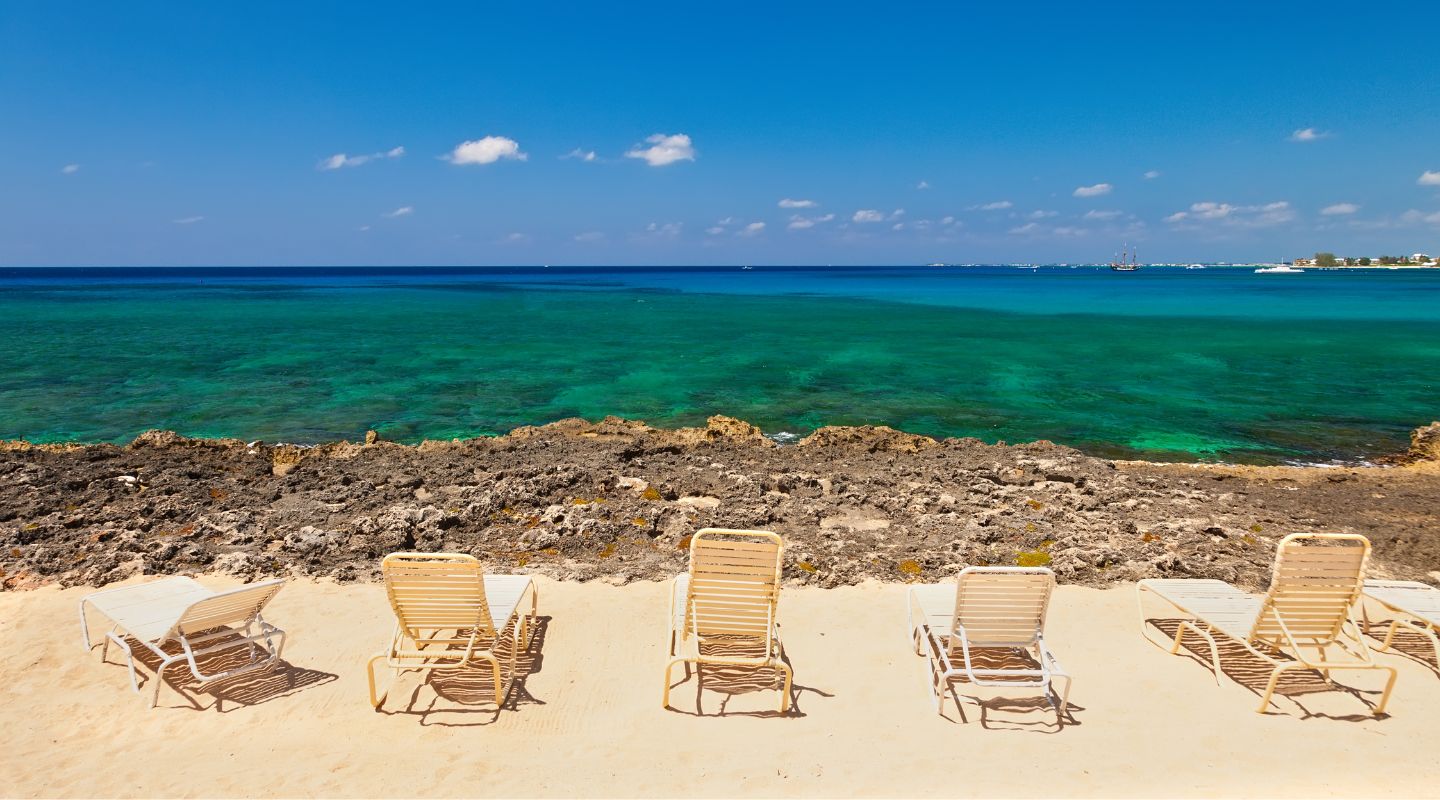 Beach chairs facing the ocean.
