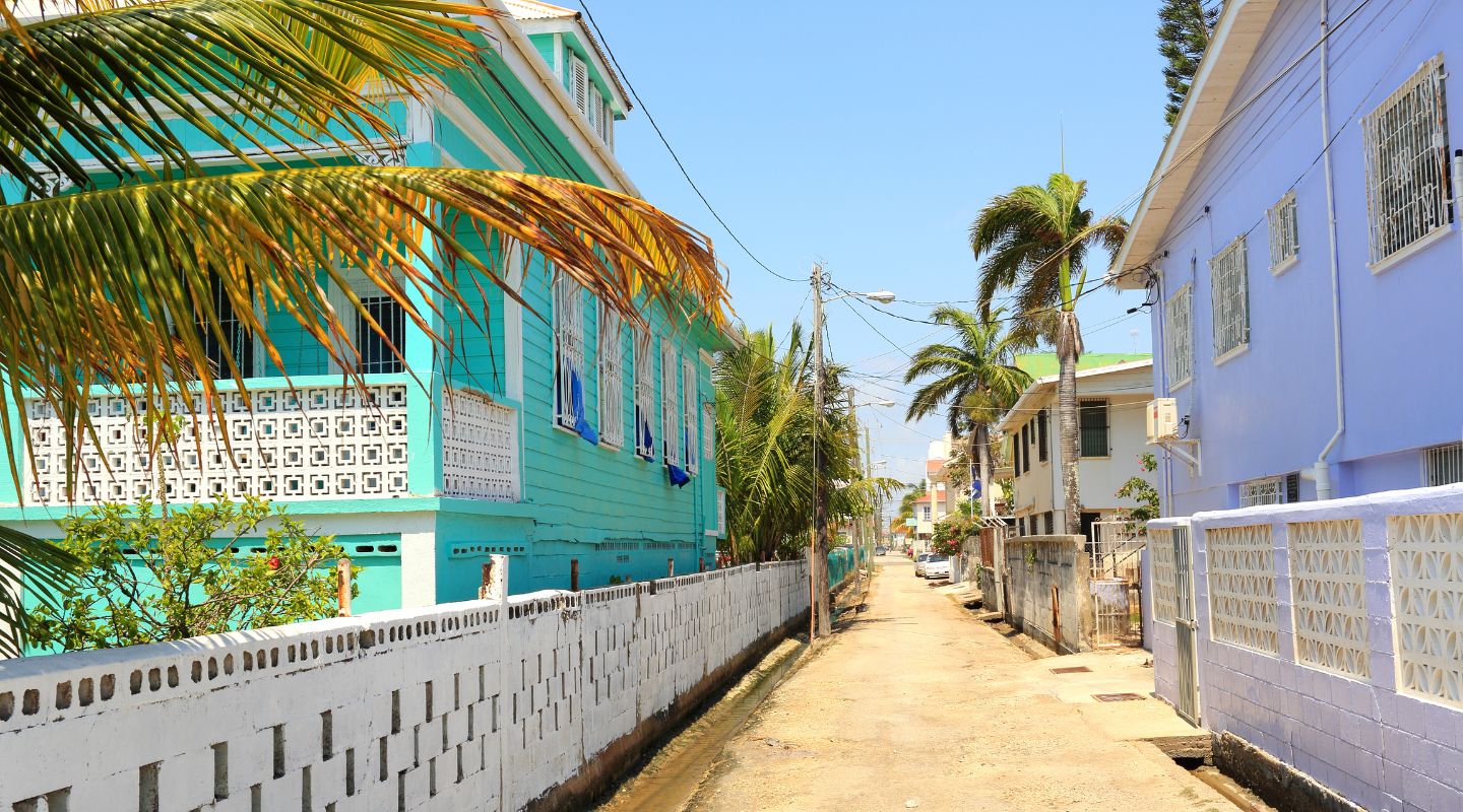 Small unpaved street between two beachfront buildings. 