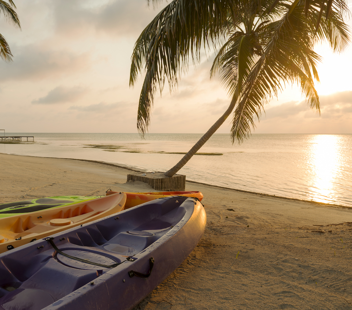 A kayak on a beach at sunrise. 