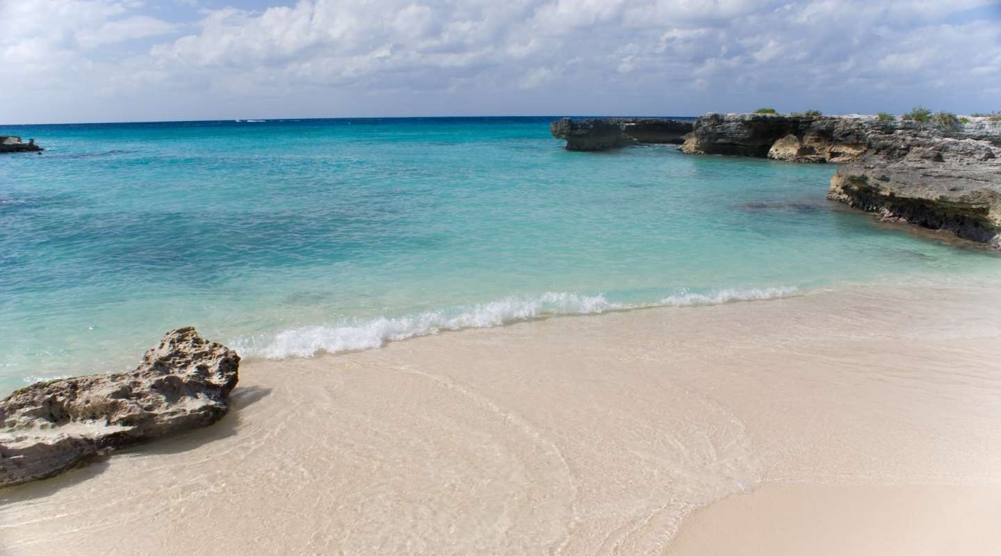 Empty beach cove and bright blue ocean