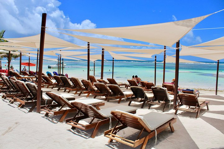 beach lounge chairs with sea in background