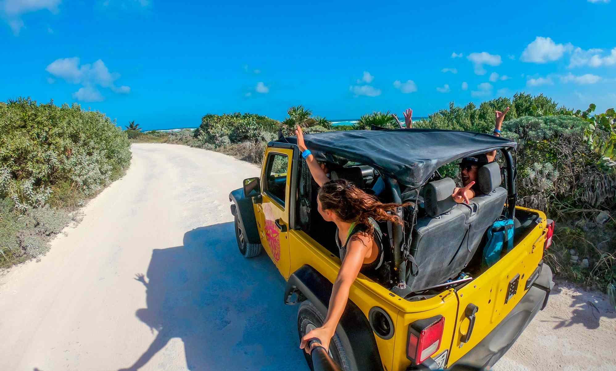 people in yellow Jeep on Cozumel island