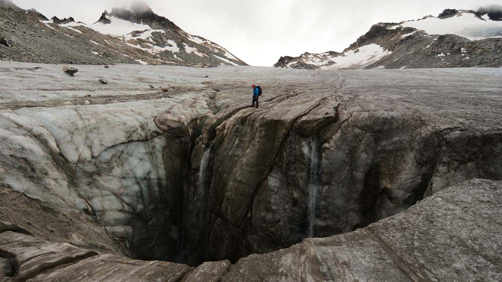 I'd scoot back a bit if I were that guy! This massive moulin (moo-LAHN) on the Snowbird Glacier in Alaska's Talkeetna Mountains is an especially large example of the usually smaller holes that often source meltwater into growing glacier ice caves. (1)