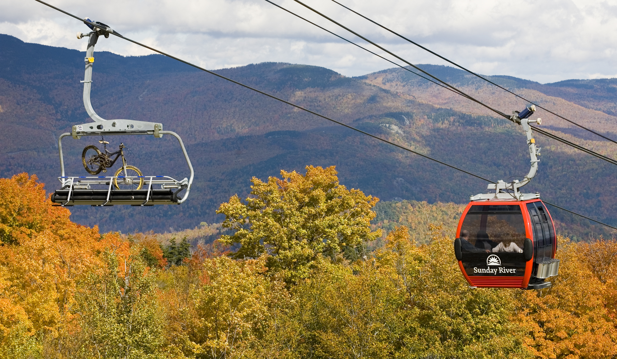 Sunday River's scenic lift rides take foot passengers and cyclists up to it's mid-mountain Peak Lodge on North Peak.
