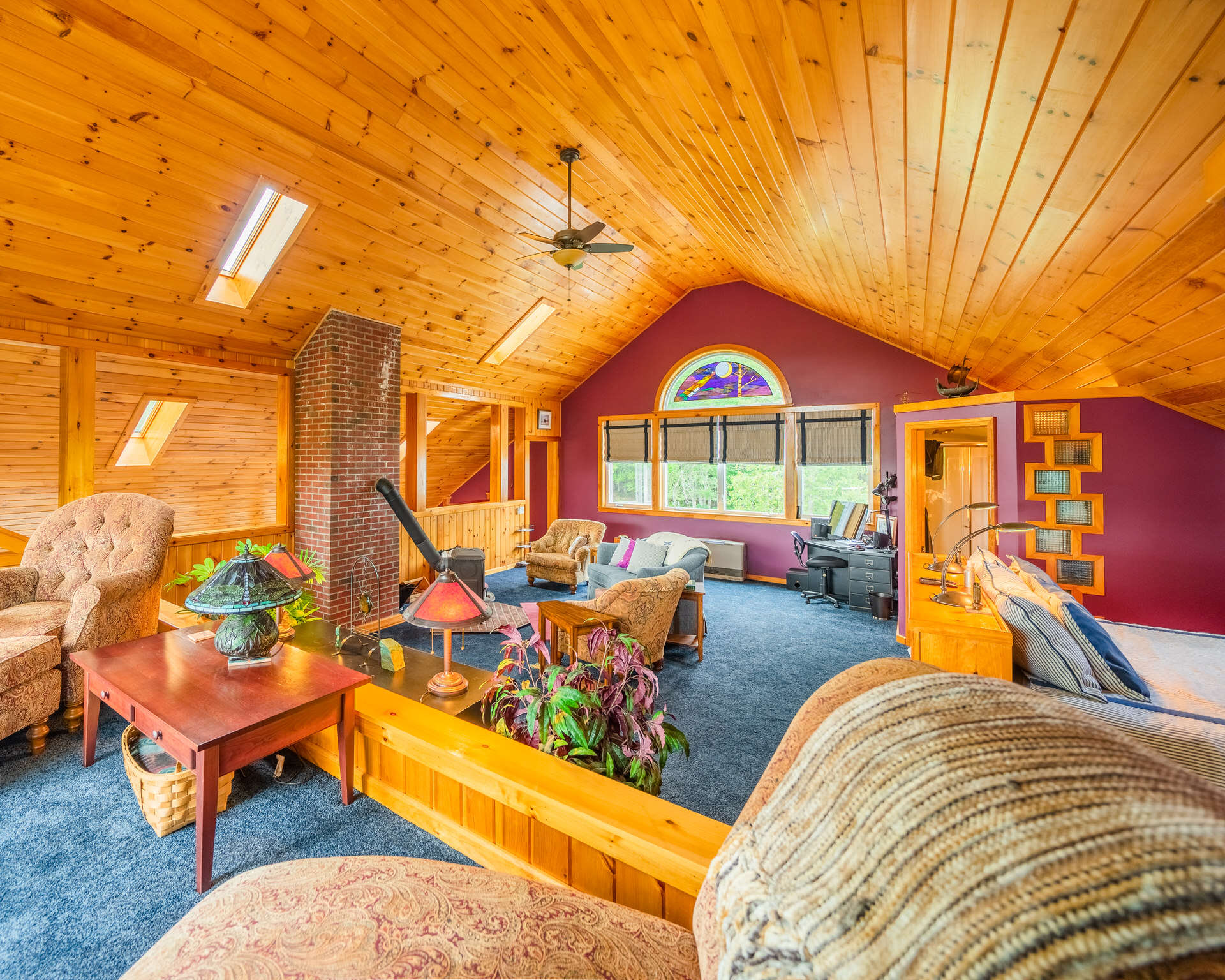 The King en-suite of the Main House, also has a full bath and a twin bed. On the third floor of the Main House, you sit high above the trees and looks out over the water.