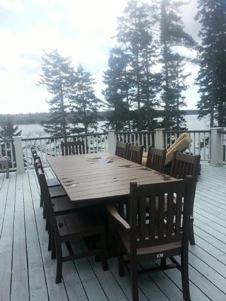 First Light Cottage - Dining on the deck for 10 plus 2 chaise lounge chairs and 6 teak rockers.
