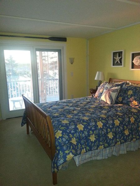 First Light Cottage - Guest bedroom w/queen bed, direct access to lower level deck through ensuite slider, faces waterfront. Private ensuite bath w/shower.