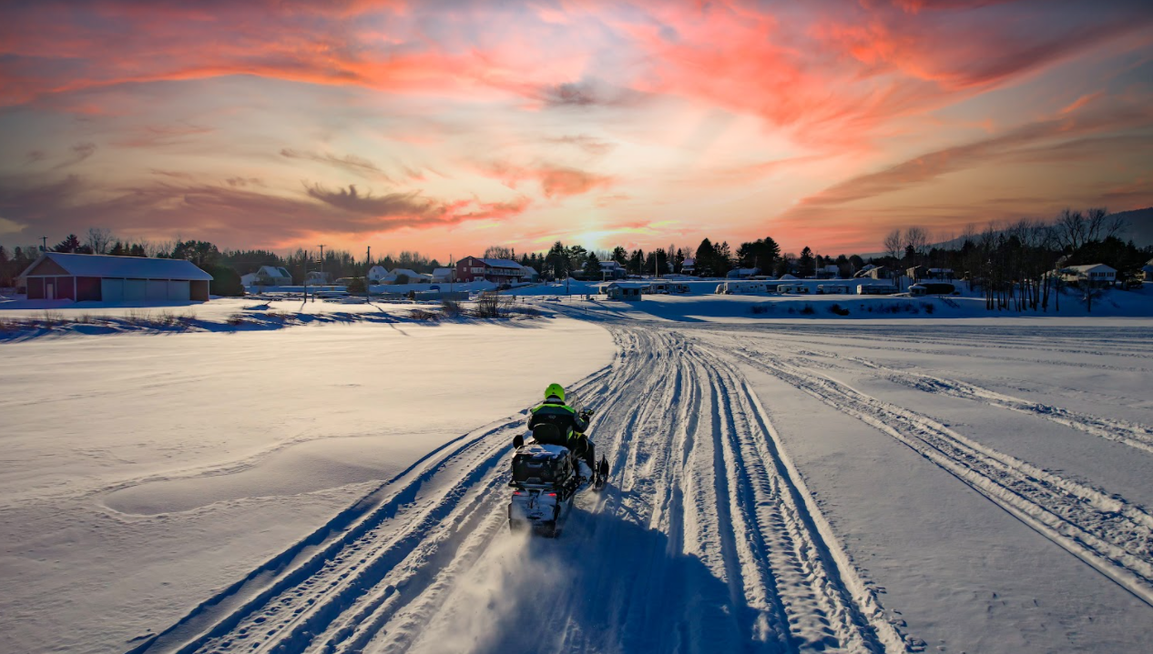 A sledder cuts accross Long Lake in St. Agatha, Maine.