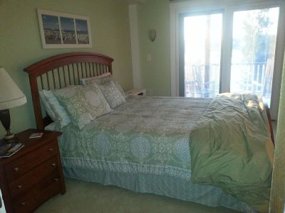 First Light Cottage - Guest bedroom w/queen bed, direct access to lower level deck through ensuite slider, faces waterfront. Private bath w/oversized shower just 2 steps away.