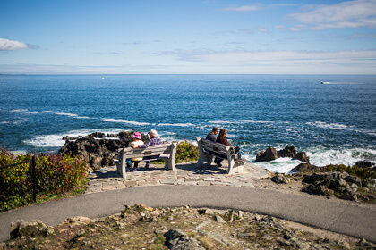 couples on benches overlooking the ocean