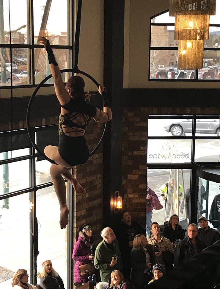 Aerialist troupe Levitation Nation performs high above the crowd at the post-parade Winter Carnival party at the Firebrand Hotel. – Dina Wood