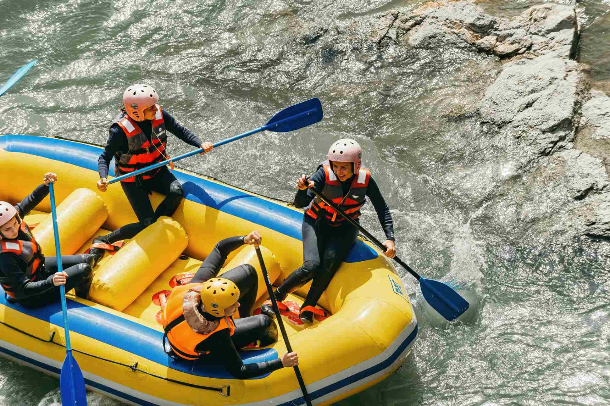 women paddling raft