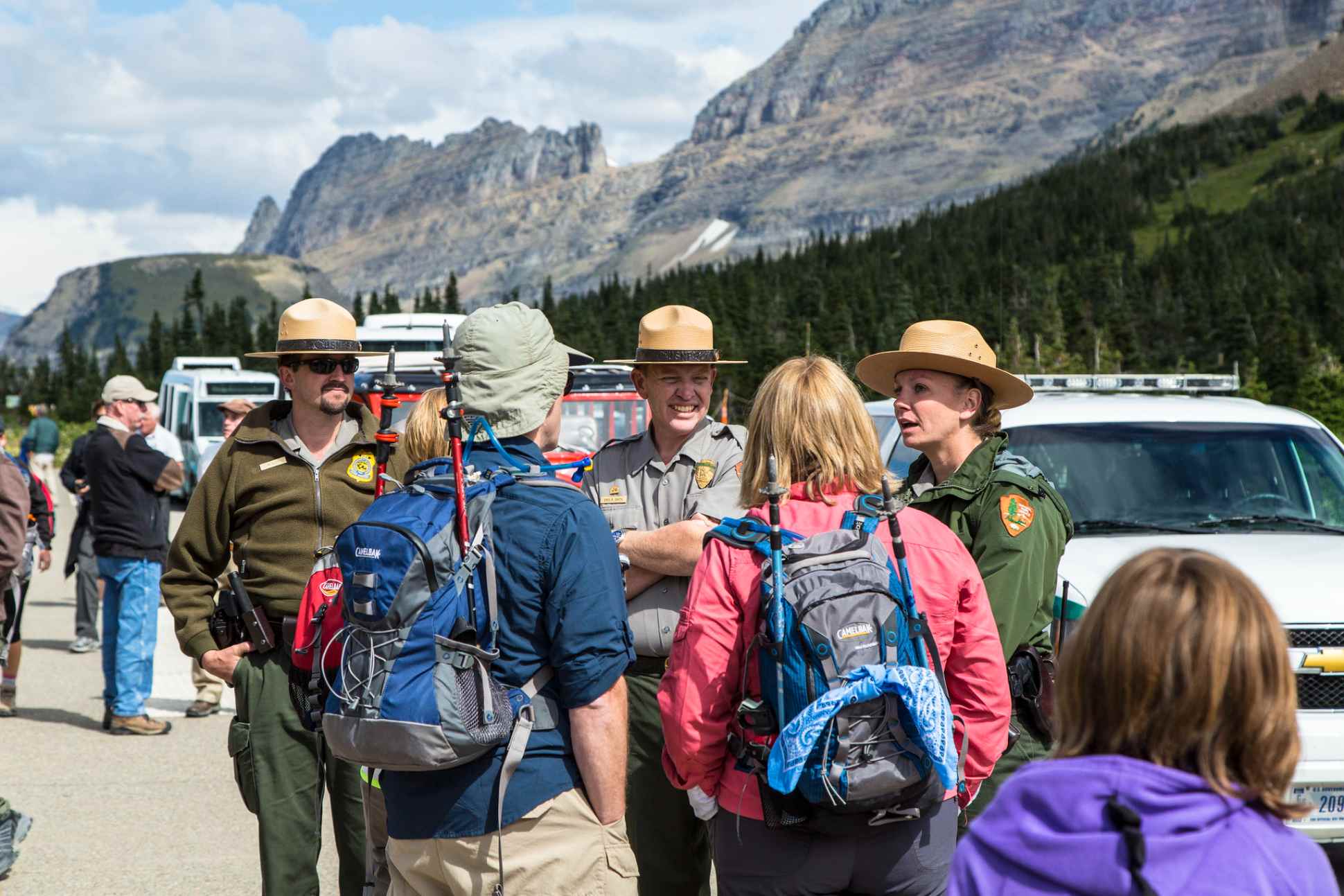 Glacier Park rangers give tips to visitors at Logan Pass