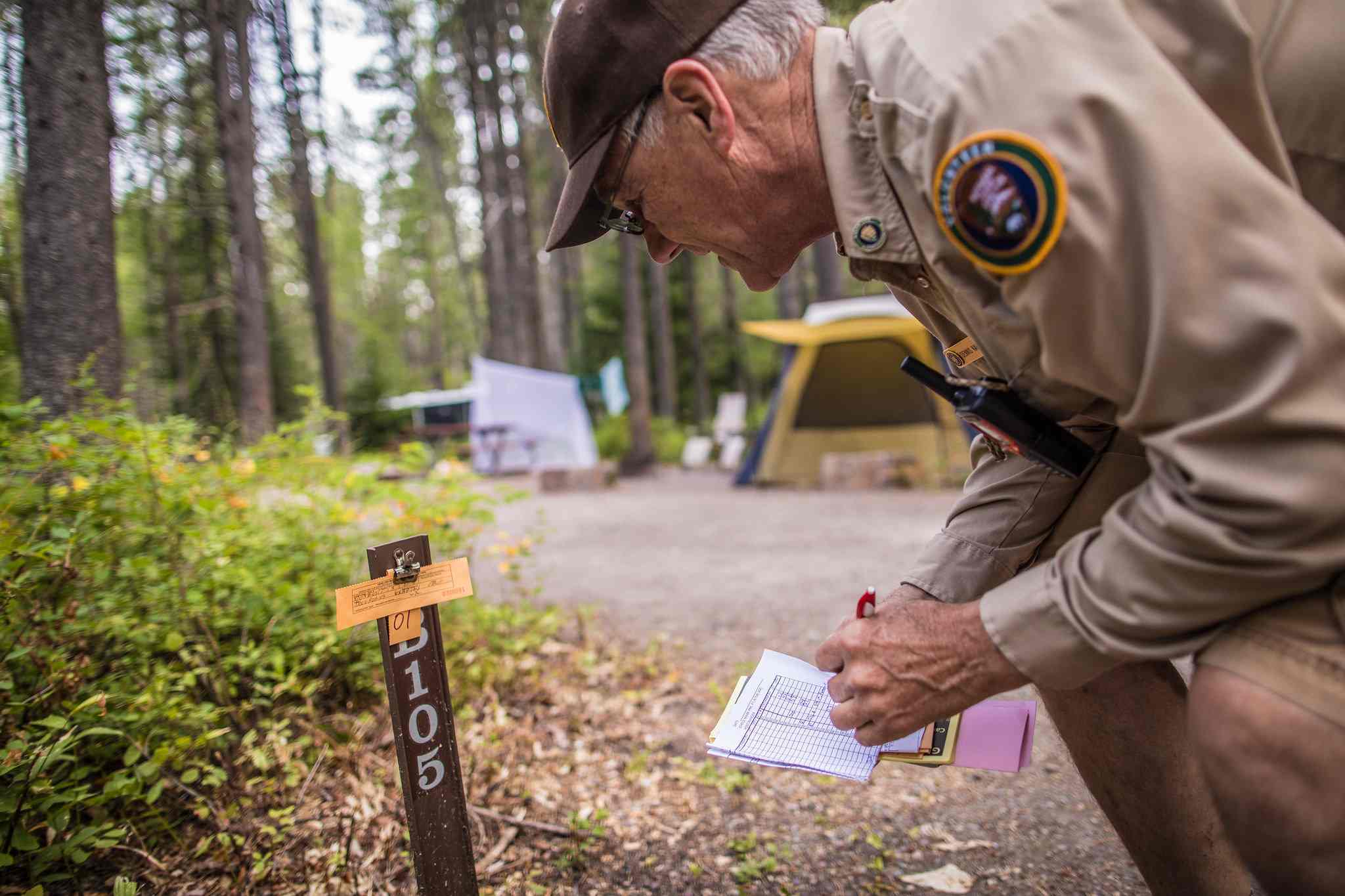 Camp host checks a reservation at campsite