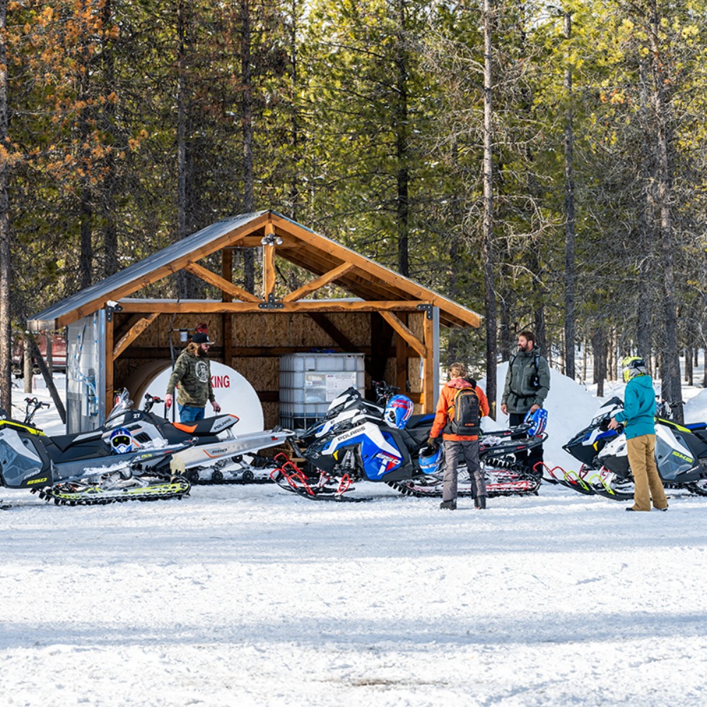 A group prepares for a snowmobile tour