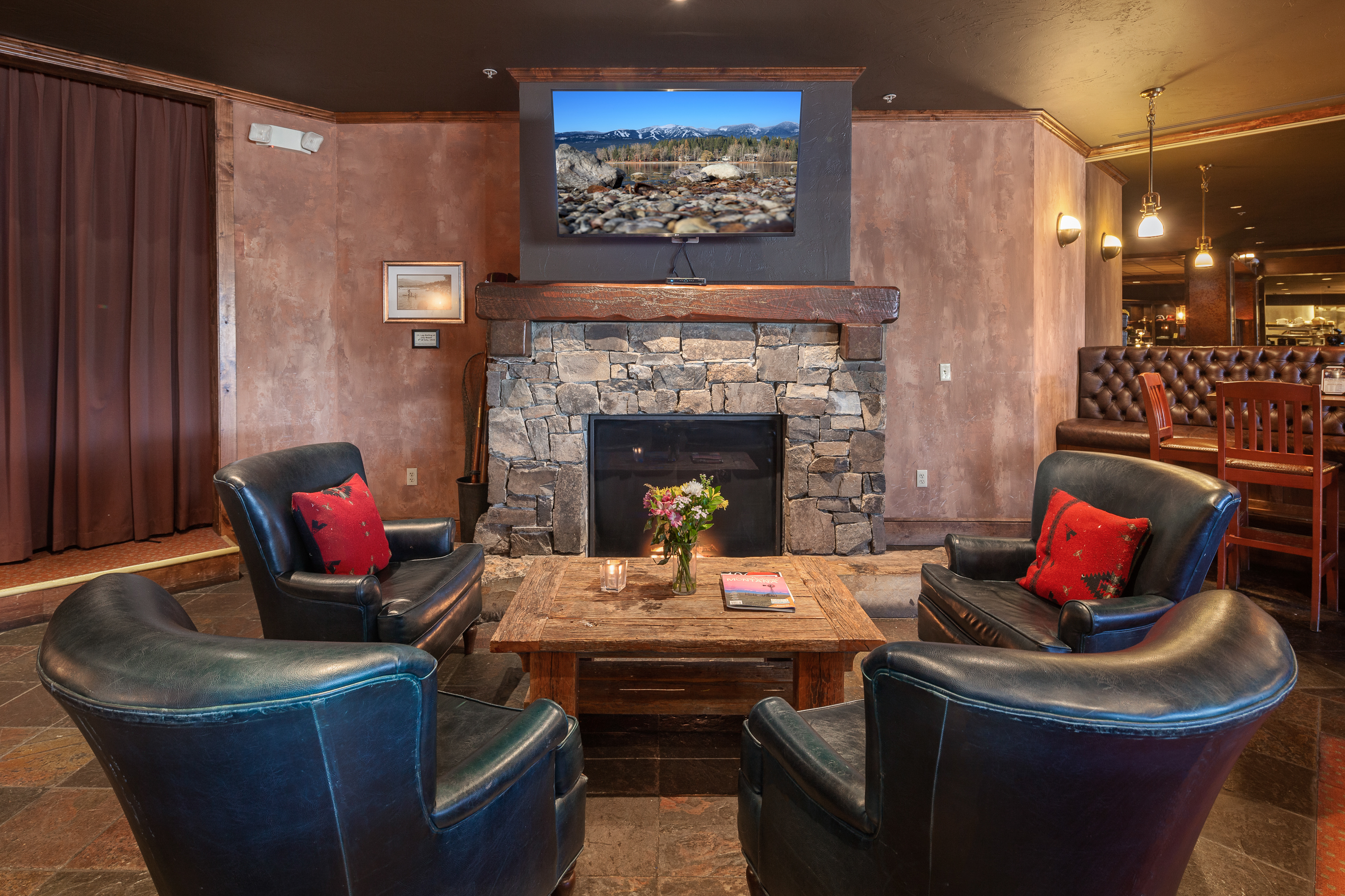 Cozy fireside seating is available in the Boat Club Bar. – Glacier View Studio