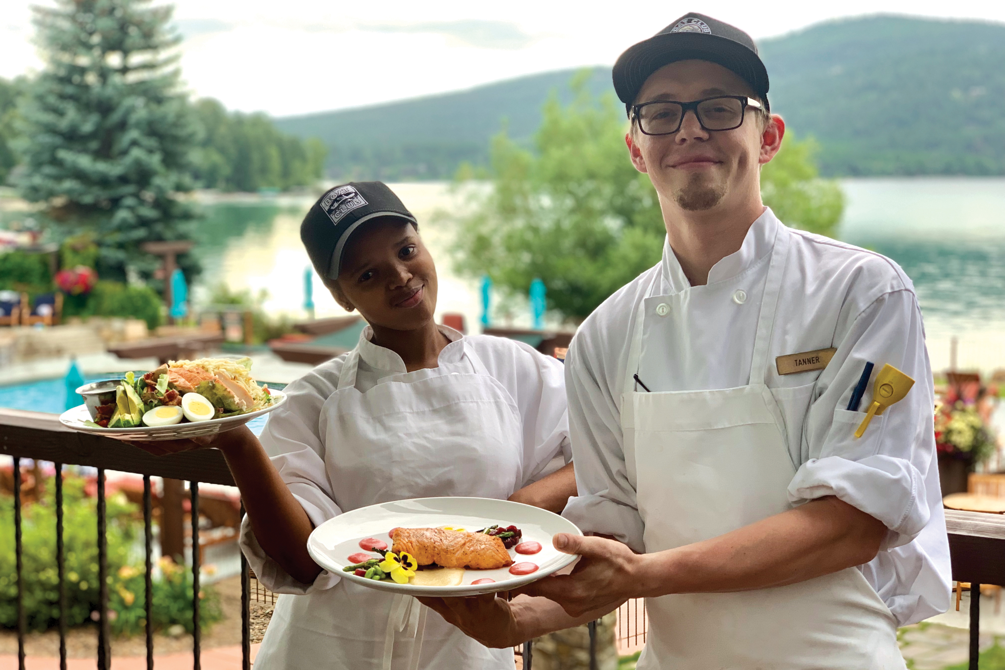 Showing off their culinary creations on the deck overlooking Whitefish Lake.